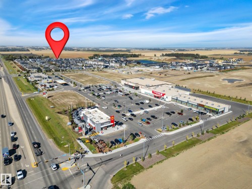 Aerial view of property and surrounding area with a commercial area - 157 Larch Crescent, Leduc, AB - Outdoor With View
