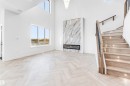 Unfurnished living room featuring stairway, a high ceiling, and a premium fireplace - 21 Trill Point(E), Spruce Grove, AB  - Indoor Photo Showing Other Room 