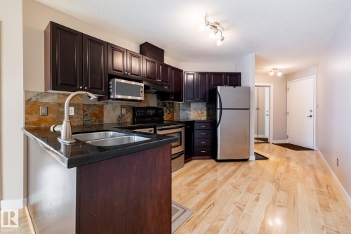 304 9336 Jasper Avenue, Edmonton, AB - Indoor Photo Showing Kitchen With Double Sink