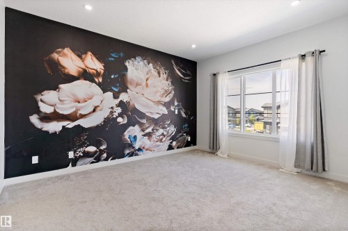 Empty room featuring an accent wall, carpet flooring, and recessed lighting - 5747 Kootook Way, Edmonton, AB - Indoor Photo Showing Other Room