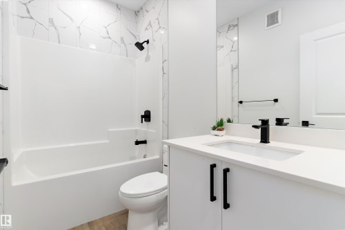 Full bath with vanity, tub / shower combination, and light wood-style floors - 5747 Kootook Way, Edmonton, AB - Indoor Photo Showing Bathroom
