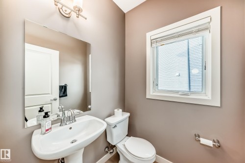 Bathroom with toilet and a sink - 1908 69 Street, Edmonton, AB - Indoor Photo Showing Bathroom