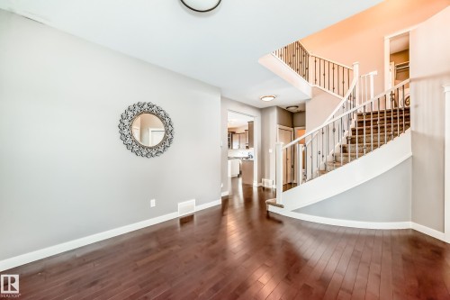 Staircase with wood-type flooring and baseboards - 1908 69 Street, Edmonton, AB - Indoor Photo Showing Other Room