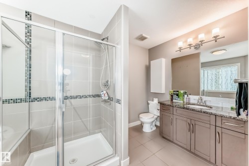 Full bath featuring vanity, a shower stall, and light tile patterned floors - 1908 69 Street, Edmonton, AB - Indoor Photo Showing Bathroom