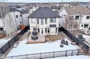 Snow covered rear of property with a wooden deck, a shingled roof, a fenced backyard, and a residential view - 1908 69 Street, Edmonton, AB  - Outdoor 