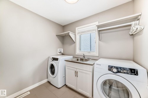 Laundry room with separate washer and dryer and cabinet space - 1908 69 Street, Edmonton, AB - Indoor Photo Showing Laundry Room