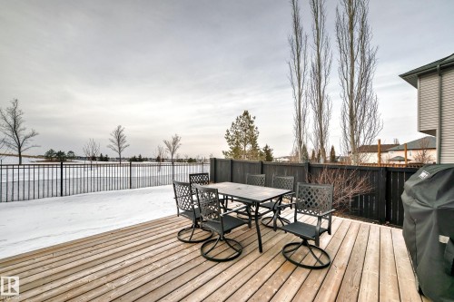 Wooden deck featuring grilling area, a fenced backyard, and outdoor dining area - 1908 69 Street, Edmonton, AB - Outdoor With Deck Patio Veranda With Exterior