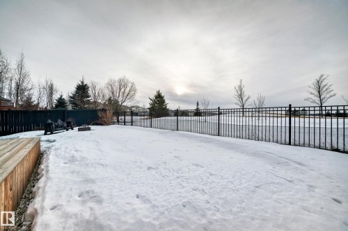 Snowy yard with a fenced backyard and a fire pit - 1908 69 Street, Edmonton, AB - Outdoor