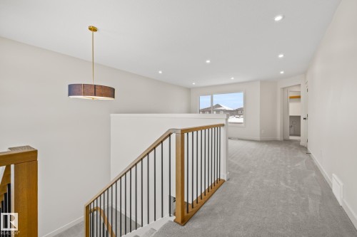 Hall with light carpet, recessed lighting, and an upstairs landing - 4543 Knight Wynd, Edmonton, AB - Indoor Photo Showing Other Room