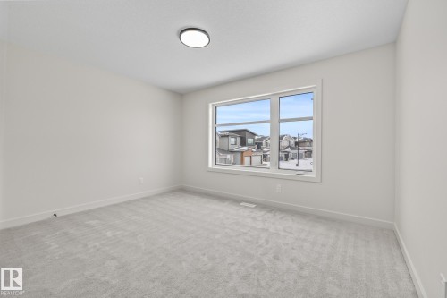 Empty room featuring light carpet and baseboards - 4543 Knight Wynd, Edmonton, AB - Indoor Photo Showing Other Room