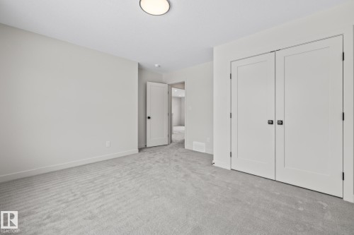 Unfurnished bedroom featuring carpet flooring and a closet - 4543 Knight Wynd, Edmonton, AB - Indoor Photo Showing Other Room