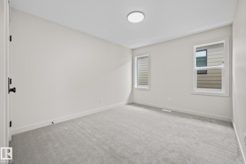 Spare room with light colored carpet and baseboards - 4543 Knight Wynd, Edmonton, AB - Indoor Photo Showing Other Room