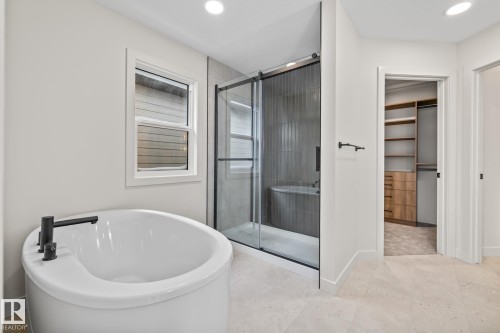 Full bath with a spacious closet, a shower stall, a freestanding bath, and recessed lighting - 4543 Knight Wynd, Edmonton, AB - Indoor Photo Showing Bathroom