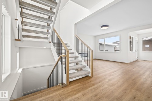 Stairway with wood finished floors and baseboards - 4543 Knight Wynd, Edmonton, AB - Indoor Photo Showing Other Room
