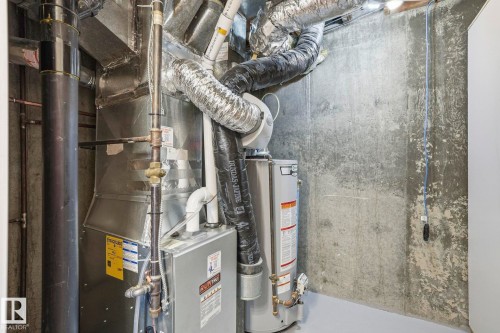 Utilities with water heater and heating unit - Edmonton, AB - Indoor Photo Showing Basement