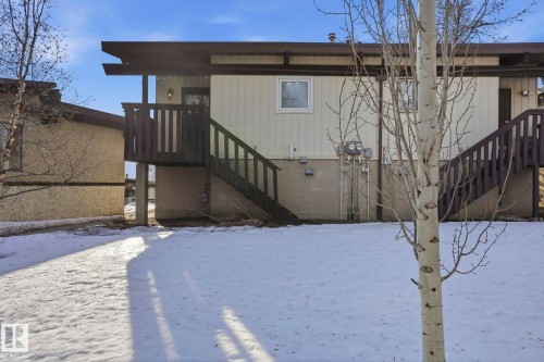 Snow covered rear of property featuring stairway - Edmonton, AB - Outdoor