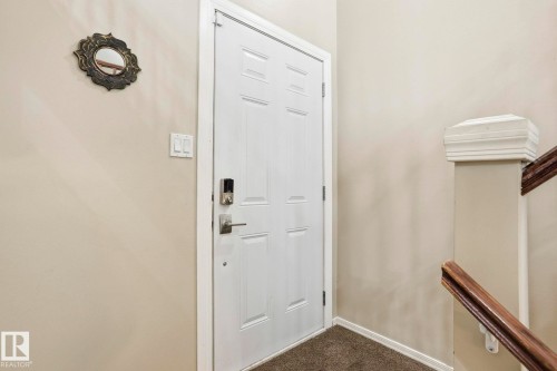 Doorway to outside featuring carpet and baseboards - Edmonton, AB - Indoor Photo Showing Other Room