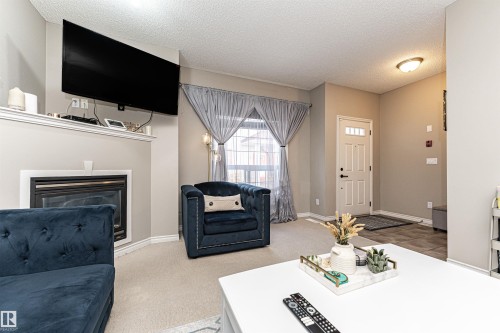 103 13825 155 Avenue, Edmonton, AB - Indoor Photo Showing Living Room With Fireplace