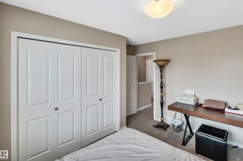 Carpeted bedroom featuring a closet and baseboards - 8 320 Secord Boulevard, Edmonton, AB - Indoor Photo Showing Bedroom