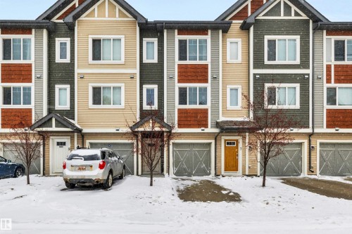 Craftsman-style home featuring an attached garage and a residential view - 8 320 Secord Boulevard, Edmonton, AB - Outdoor With Facade