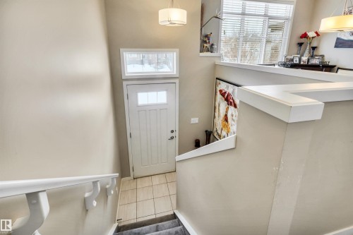Tiled entrance foyer featuring healthy amount of natural light - 8 320 Secord Boulevard, Edmonton, AB - Indoor Photo Showing Other Room