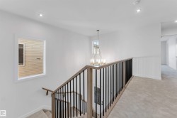Stairway with carpet floors, recessed lighting, and a chandelier - 