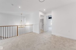 Unfurnished room featuring recessed lighting, carpet, and a chandelier - 