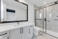 Bathroom with vanity, light marble finish floors, a marble finish shower, and recessed lighting - 