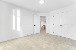 Unfurnished bedroom featuring light carpet and a closet - 