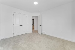 Unfurnished bedroom with light carpet and a closet - 