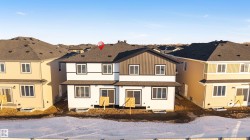 View of front of property featuring a shingled roof, a residential view, and board and batten siding - 