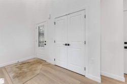 Foyer entrance with light wood-style floors and baseboards - 