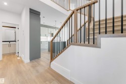 Stairway featuring wood finished floors and baseboards - 