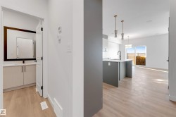 Corridor with light wood-type flooring and a sink - 