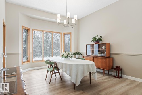 Dining area with light wood-type flooring and hanging lights - 121 Weaver Drive, Edmonton, AB - Indoor Photo Showing Dining Room