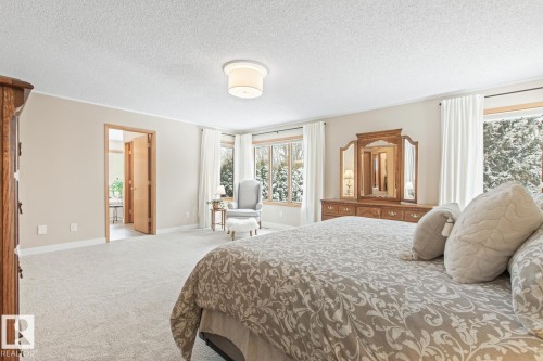 Carpeted bedroom featuring baseboards and a textured ceiling - 121 Weaver Drive, Edmonton, AB - Indoor Photo Showing Bedroom