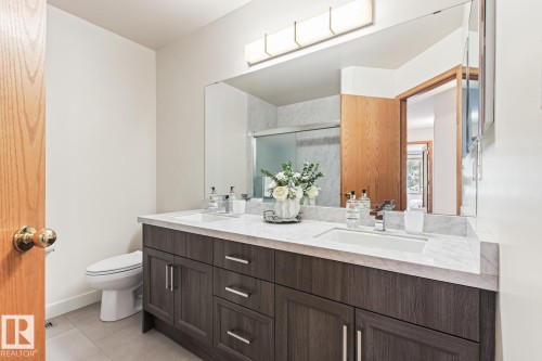 Full bathroom with double vanity, a shower stall, and light tile patterned flooring - 121 Weaver Drive, Edmonton, AB - Indoor Photo Showing Bathroom