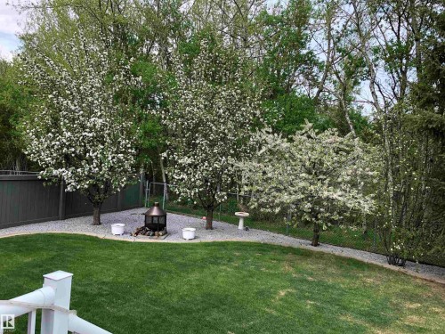 Fenced backyard with a fire pit and a patio area - 121 Weaver Drive, Edmonton, AB - Outdoor