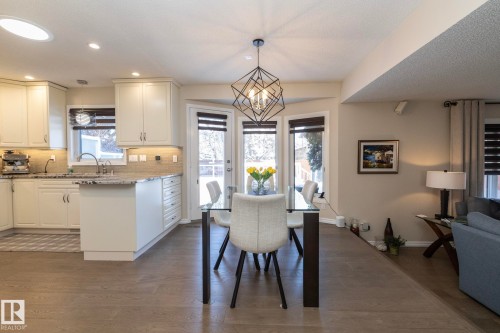Dining area with dark wood-style flooring and hanging lights - 932 110A Street, Edmonton, AB - Indoor