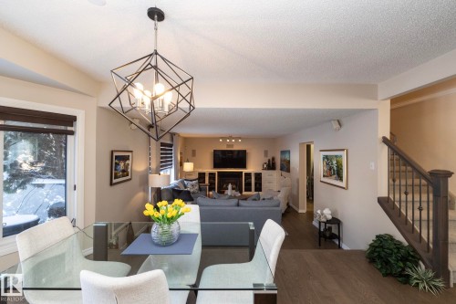 Kitchen with stainless steel appliances, light stone counters, recessed lighting, white cabinets, and dark wood-type flooring - 932 110A Street, Edmonton, AB - Indoor Photo Showing Dining Room