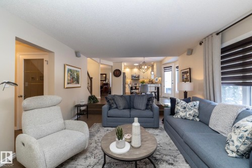 Living area featuring a chandelier and baseboards - 932 110A Street, Edmonton, AB - Indoor Photo Showing Living Room