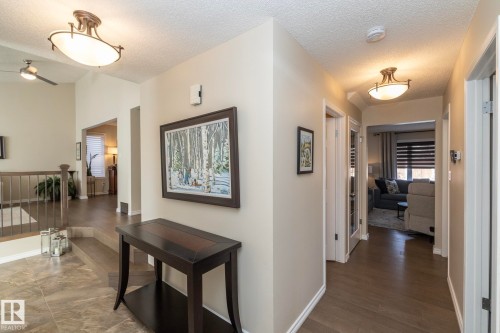 Hall featuring a textured ceiling and an upstairs landing - 932 110A Street, Edmonton, AB - Indoor Photo Showing Other Room