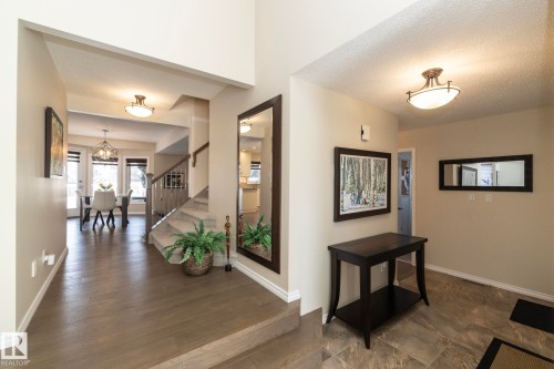 Foyer entrance with a textured ceiling, a chandelier, and dark wood-style floors - 932 110A Street, Edmonton, AB - Indoor Photo Showing Other Room