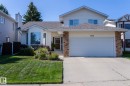 View of front facade featuring a shingled roof, an attached garage, driveway, a front yard, and brick siding - 932 110A Street, Edmonton, AB  - Outdoor With Facade 