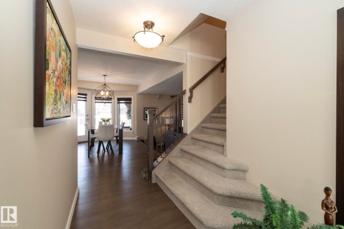 Stairway featuring wood finished floors and a textured ceiling - 932 110A Street, Edmonton, AB - Indoor Photo Showing Other Room