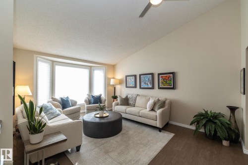 Living room featuring dark wood-type flooring and ceiling fan - 932 110A Street, Edmonton, AB - Indoor Photo Showing Living Room