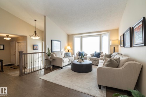Living room featuring wood finished floors and a high textured ceiling - 932 110A Street, Edmonton, AB - Indoor Photo Showing Living Room