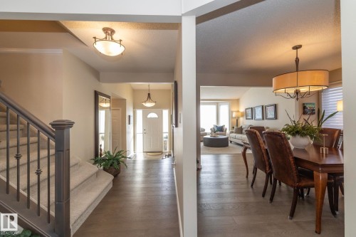 Foyer with hardwood / wood-style floors, a textured ceiling, and suspended lighting - 932 110A Street, Edmonton, AB - Indoor Photo Showing Other Room
