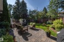Fenced backyard with a patio area, an outdoor living space with a fire pit, area for grilling, and a deck - 932 110A Street, Edmonton, AB  - Outdoor With Deck Patio Veranda With Backyard 