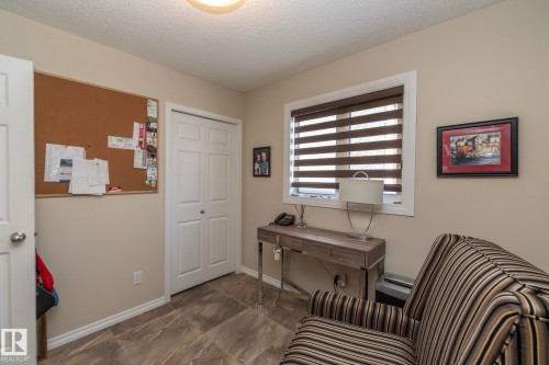 Office space featuring a textured ceiling and baseboards - 932 110A Street, Edmonton, AB - Indoor